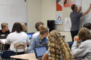 students in classroom with Chromebooks