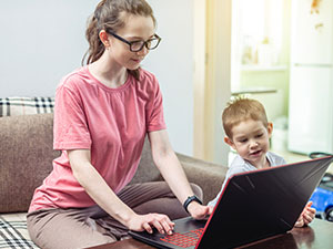 parent on laptop with child