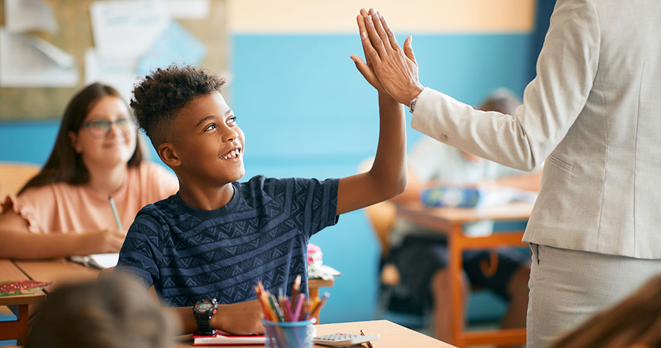 student and teacher high five